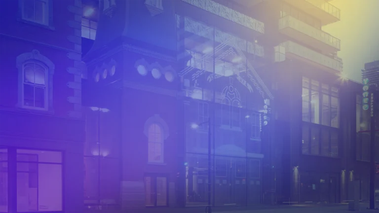 Modern mixed-use building with a glass façade integrated into a historic brick structure at street level, illuminated at dusk. A blue and purple gradient overlay softens the image, with balconies visible on the upper floors and storefront windows along the sidewalk.