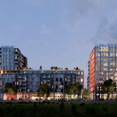 A view of a modern residential or commercial complex at dusk.