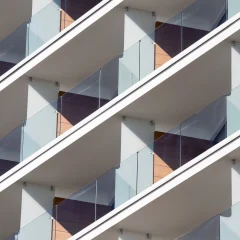 A close-up of a building's repetitive balcony pattern.
