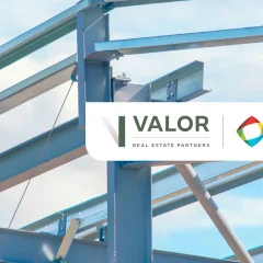 Steel framing of a building against a blue sky.